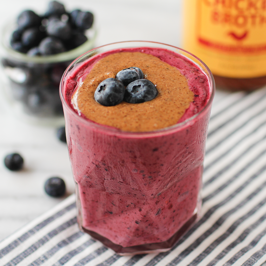 Zoup peanut butter jelly smoothie in glass with blueberries